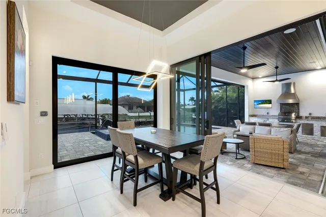 a dining room with furniture and large windows