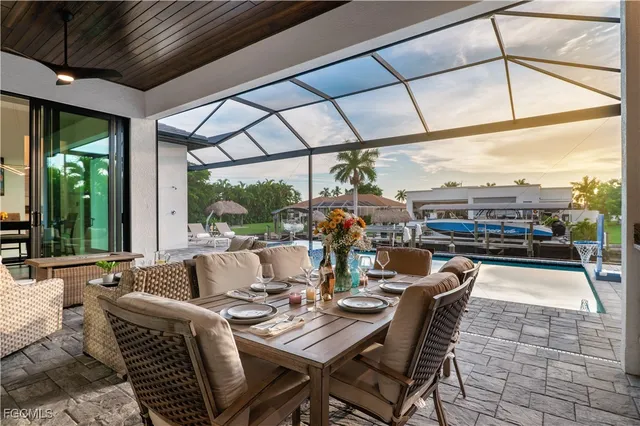 a dining room with furniture a flat screen tv and outdoor view