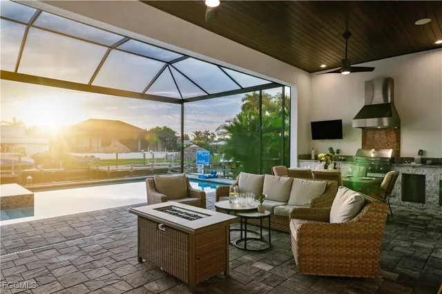 a living room with patio furniture and a floor to ceiling window