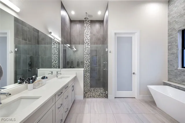 a spacious bathroom with a double vanity sink mirror and shower