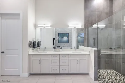 a bathroom with a double vanity sink and mirror
