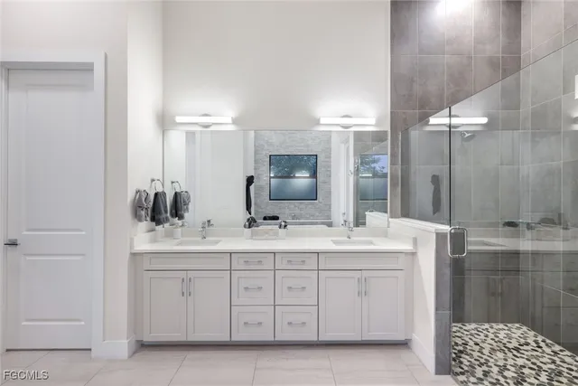 a bathroom with a double vanity sink and mirror