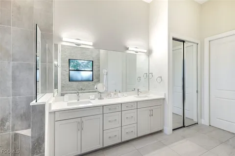 a bathroom with a double vanity sink and mirror