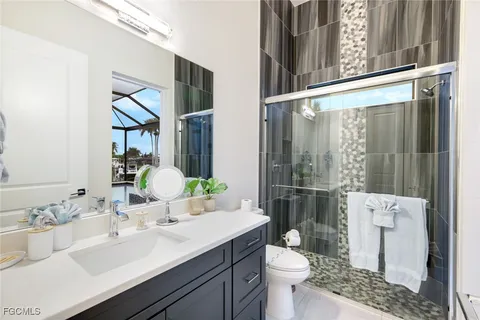 a bathroom with a sink toilet and shower