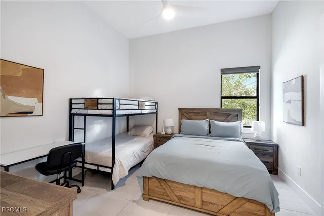 a bedroom with two beds and a desk