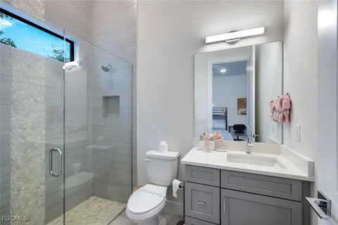 a bathroom with a sink toilet and shower
