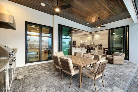 a dining room with furniture and large windows