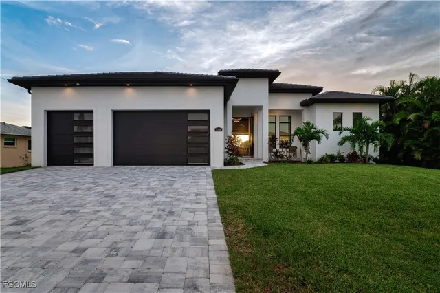a front view of a house with a yard and garage