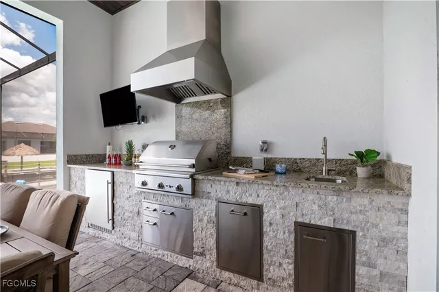 a kitchen with stainless steel appliances granite countertop a sink and a stove