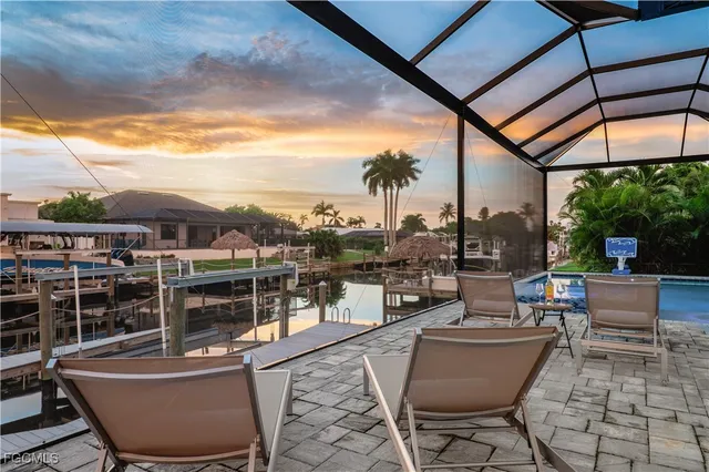 a view of a living room with furniture and floor to ceiling window