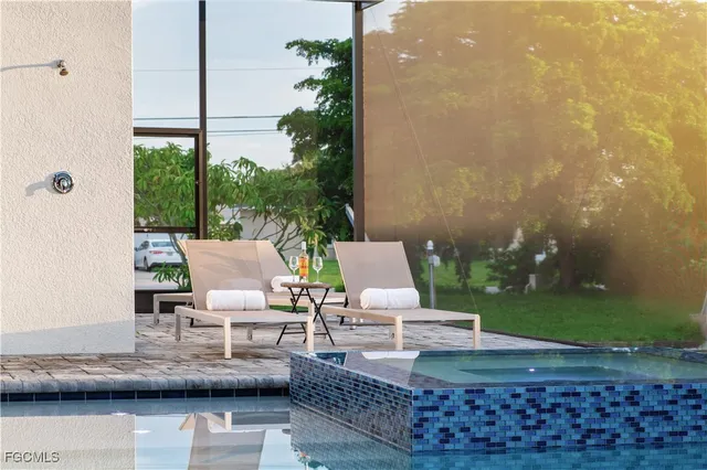 a view of a lake with a table and chairs under an umbrella