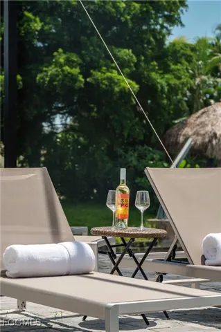 a view of a house with backyard porch and sitting area