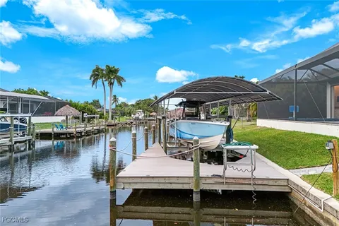 a view of a yard with furniture and lake view