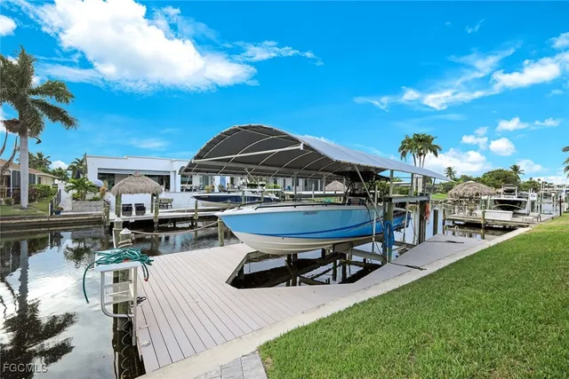 a view of a house with swimming pool and sitting area