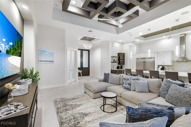 a living room with furniture and a chandelier