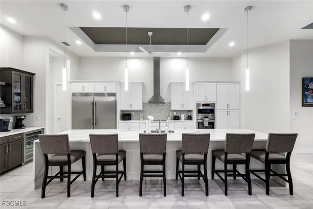 a large kitchen with a table and chairs