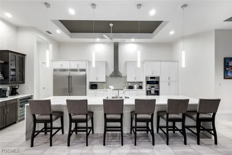 a large kitchen with a table and chairs