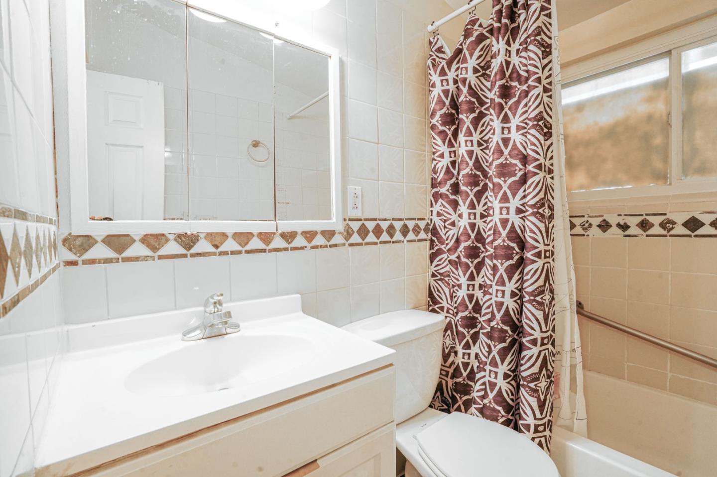 125 Rinaldo Drive Vallejo, CA 94589 - Photo 14 of 36 a bathroom with a sink a toilet and a mirror