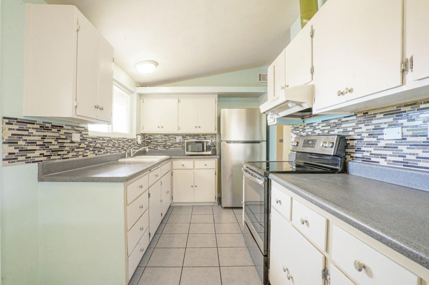 125 Rinaldo Drive Vallejo, CA 94589 - Photo 8 of 36 a kitchen with granite countertop a sink stove and cabinets