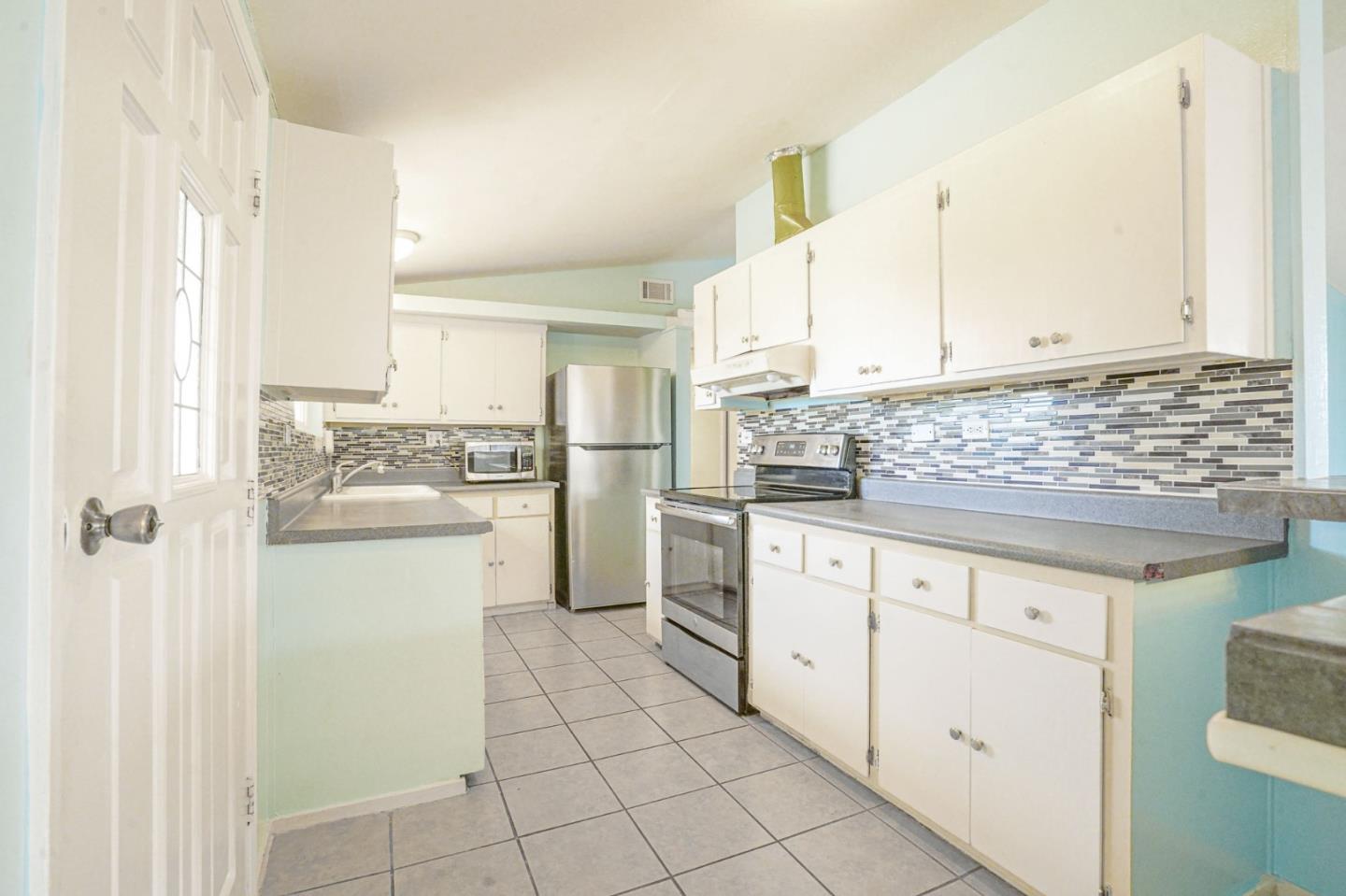 125 Rinaldo Drive Vallejo, CA 94589 - Photo 9 of 36 a kitchen with white cabinets and white appliances