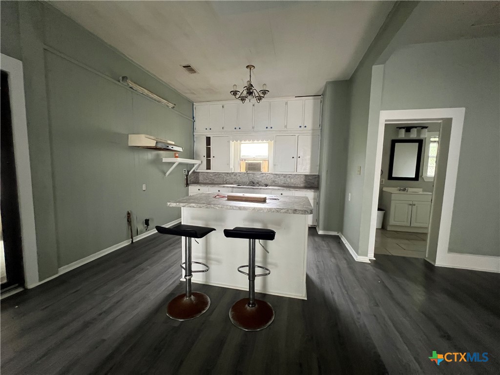 607 North Cleveland Street Victoria, TX 77901 - Photo 3 of 9 a view of dining room with furniture and wooden floor