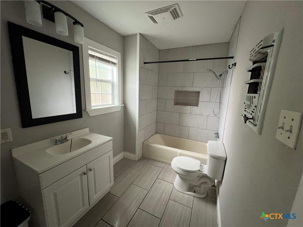607 North Cleveland Street Victoria, TX 77901 - Photo 7 of 9 a bathroom with a sink a toilet and shower
