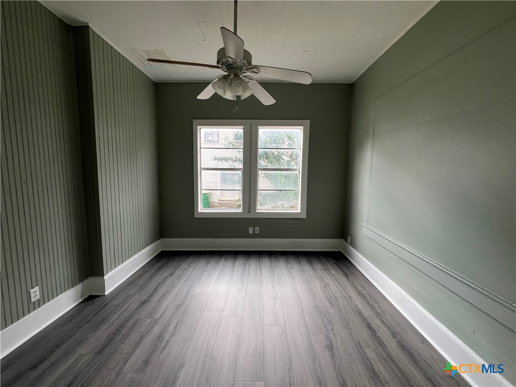 607 North Cleveland Street Victoria, TX 77901 - Photo 8 of 9 wooden floor in an empty room with a window