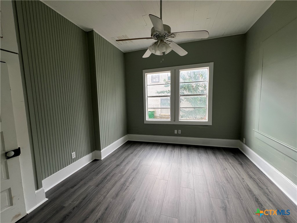 607 North Cleveland Street Victoria, TX 77901 - Photo 9 of 9 a view of an empty room with wooden floor and a window