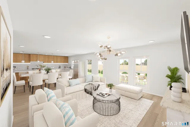 a living room with furniture and a chandelier