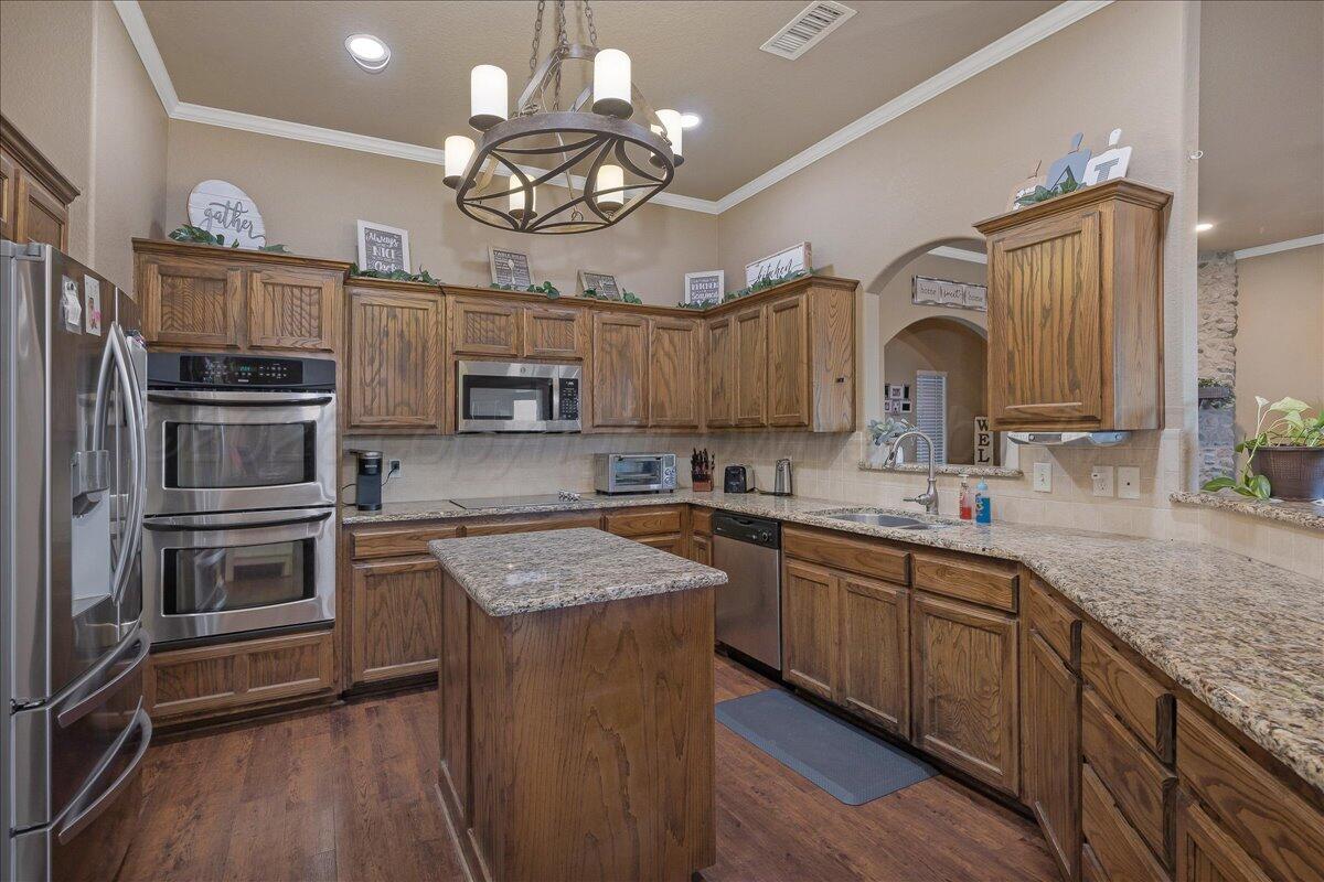 4801 Cedar Springs Trail Amarillo, TX 79119 - Photo 11 of 41 a kitchen with a sink stainless steel appliances and cabinets