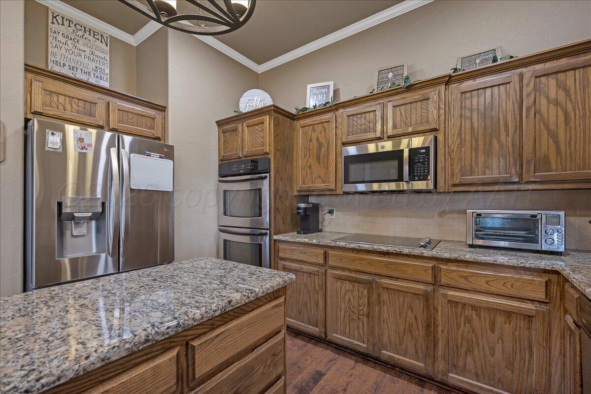 4801 Cedar Springs Trail Amarillo, TX 79119 - Photo 12 of 41 a kitchen with stainless steel appliances granite countertop a refrigerator and microwave