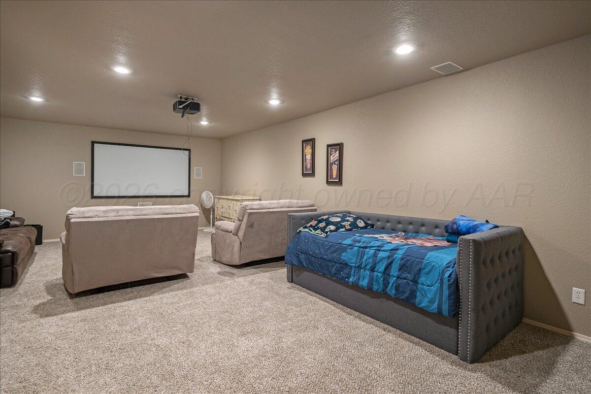 4801 Cedar Springs Trail Amarillo, TX 79119 - Photo 25 of 41 a living room with a couch and a flat screen tv