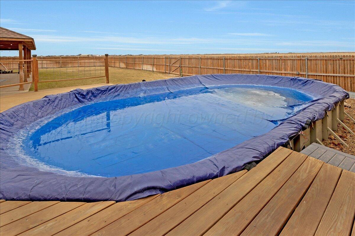 4801 Cedar Springs Trail Amarillo, TX 79119 - Photo 31 of 41 a view of a swimming pool with an ocean view