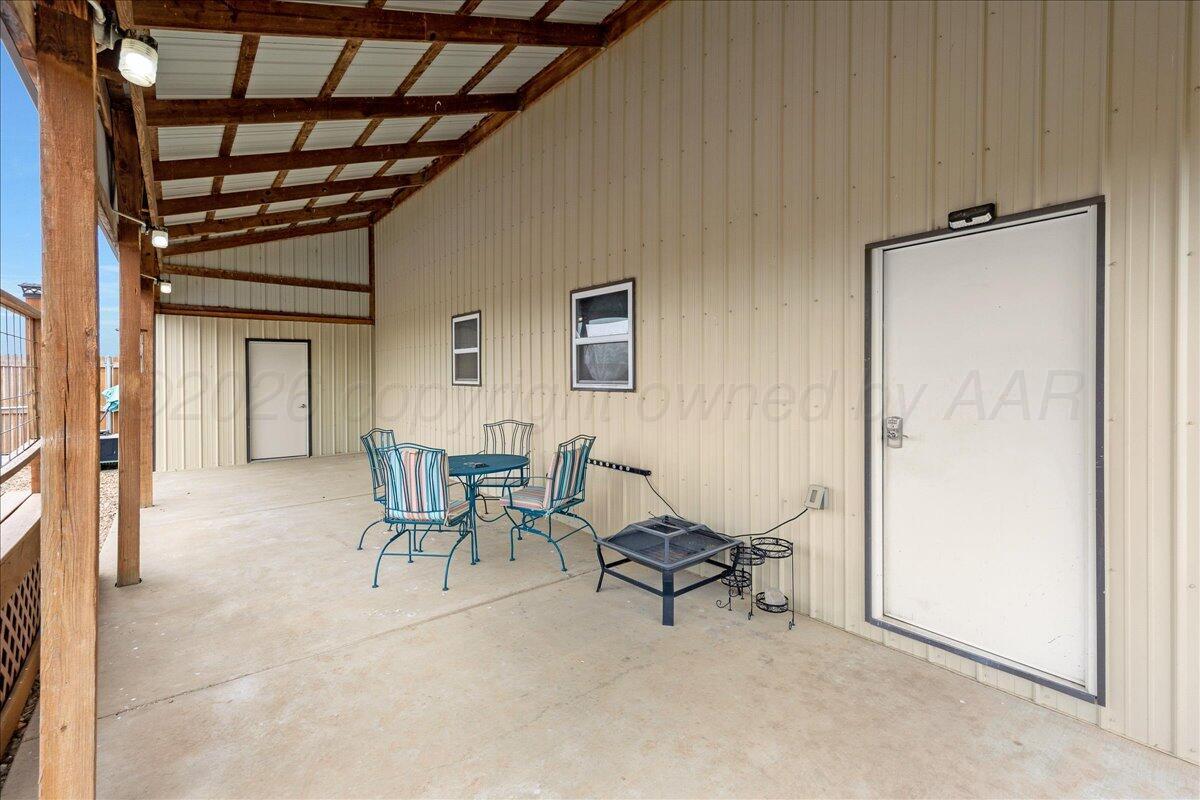4801 Cedar Springs Trail Amarillo, TX 79119 - Photo 33 of 41 a view of a hallway with chairs and a refrigerator