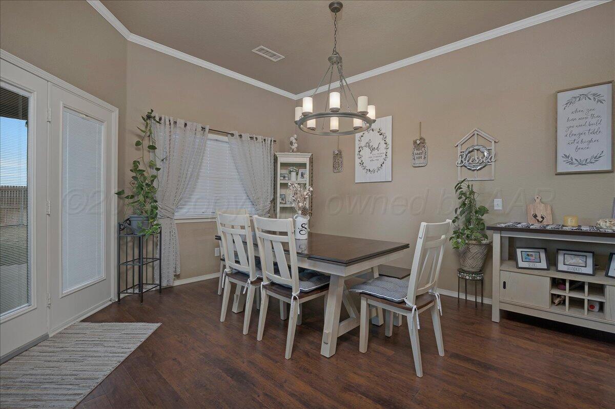 4801 Cedar Springs Trail Amarillo, TX 79119 - Photo 9 of 41 a view of a dining room with furniture wooden floor and chandelier