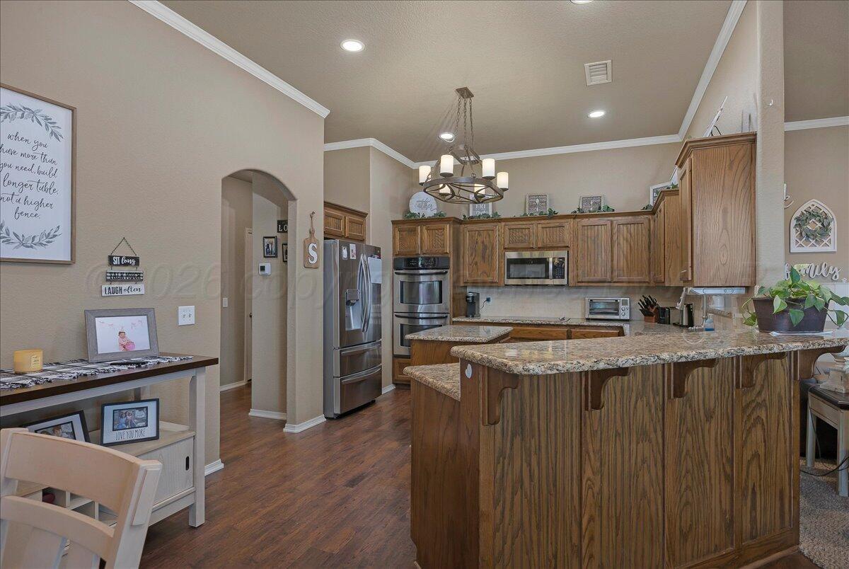 4801 Cedar Springs Trail Amarillo, TX 79119 - Photo 10 of 41 a kitchen with granite countertop a stove and cabinets