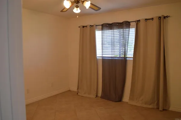 a view of a livingroom with a chandelier fan