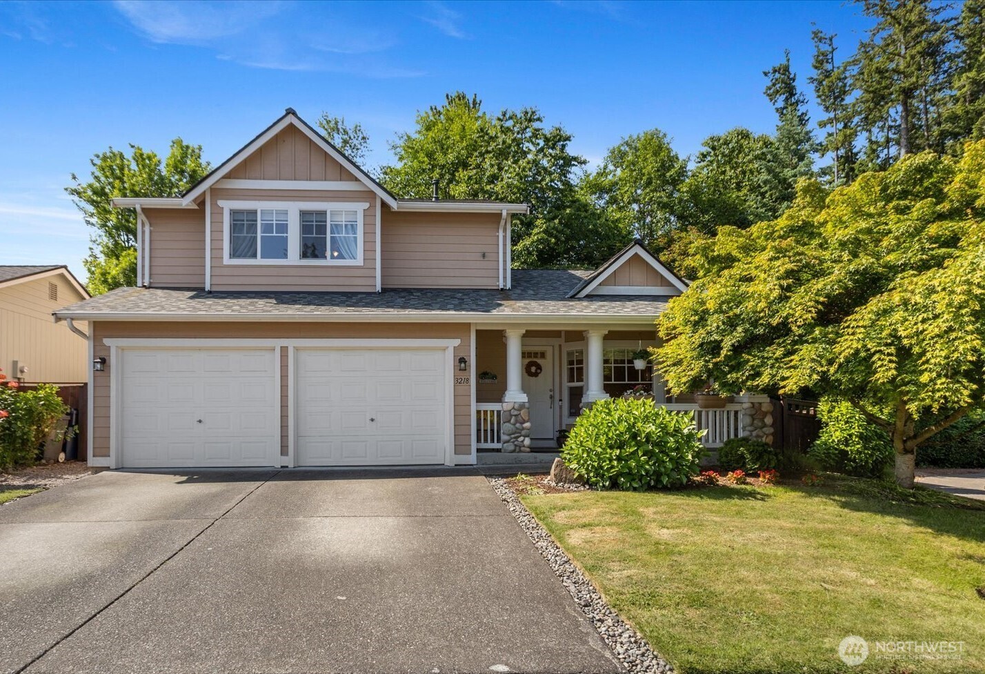 a front view of a house with a garden