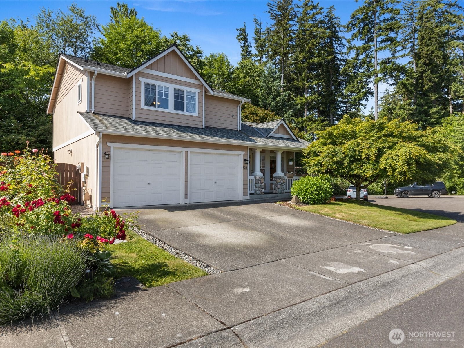3218 189th Street Southeast Bothell, WA 98012 - Photo 2 of 40 a front view of a house with a yard and garage