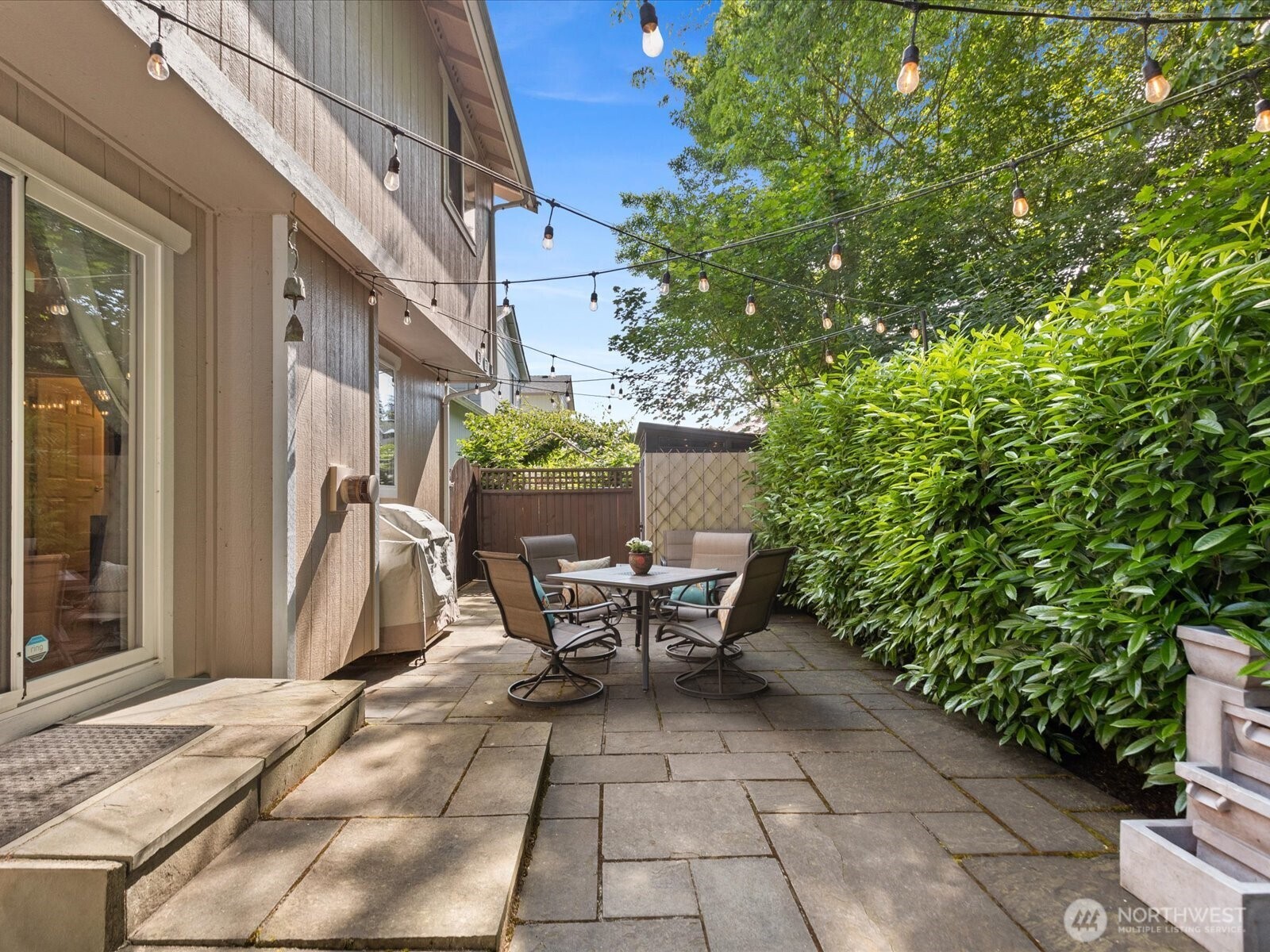 3218 189th Street Southeast Bothell, WA 98012 - Photo 29 of 40 a view of a patio with table and chairs and potted plants