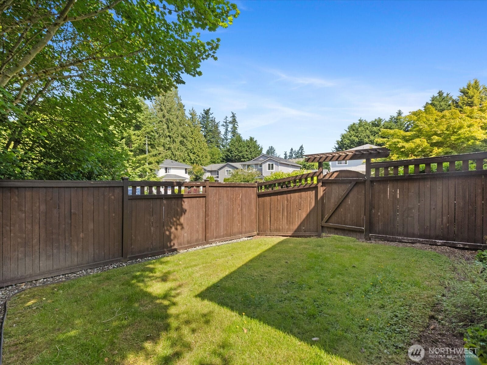 3218 189th Street Southeast Bothell, WA 98012 - Photo 32 of 40 a view of a backyard with a wooden fence