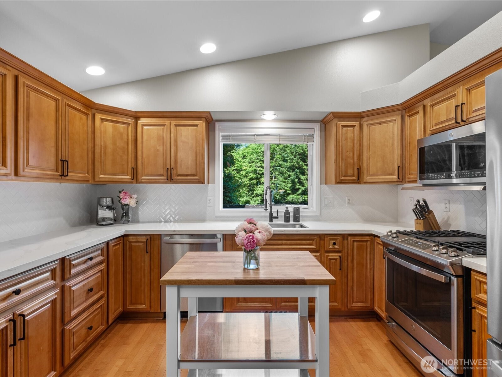 3218 189th Street Southeast Bothell, WA 98012 - Photo 10 of 40 a kitchen with stainless steel appliances a sink stove and cabinets