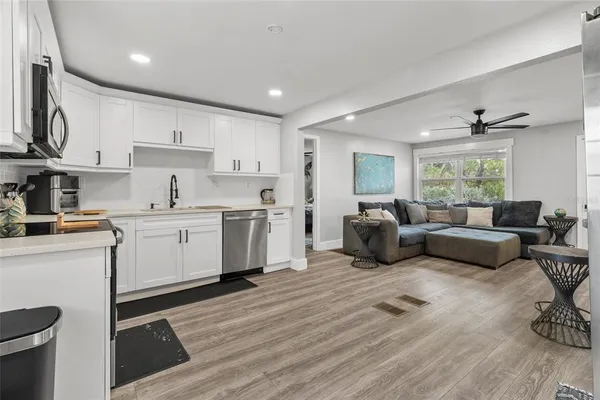 a kitchen with white cabinets stainless steel appliances and sink