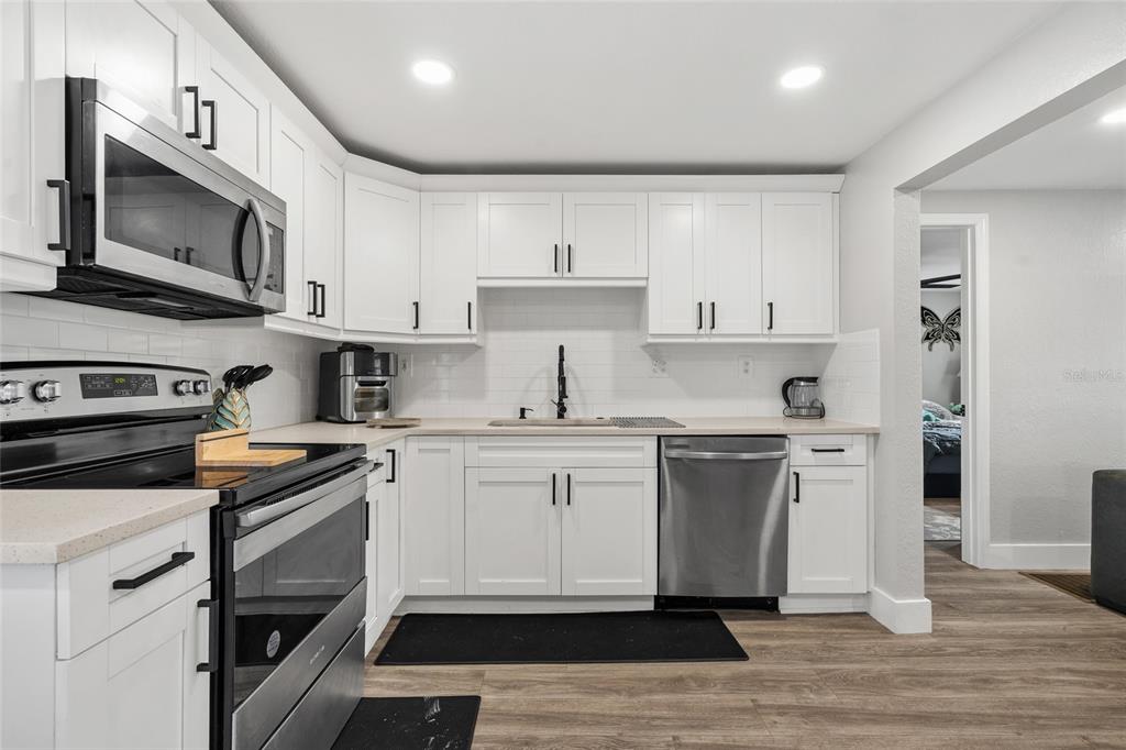 5135 Bradenton Road Sarasota, FL 34234 - Photo 13 of 30 a kitchen with white cabinets stainless steel appliances and sink
