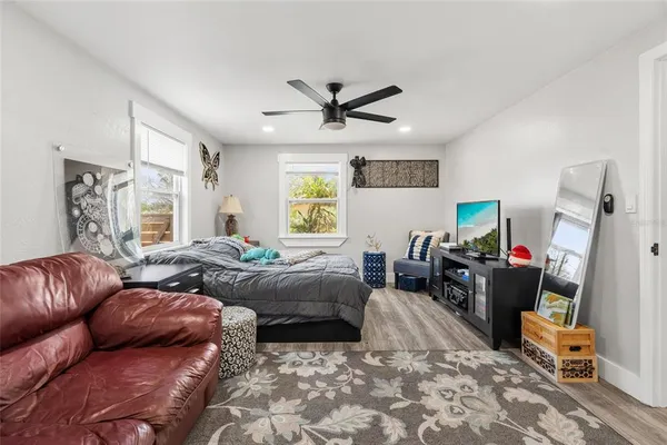 a bedroom with a large bed and a chandelier