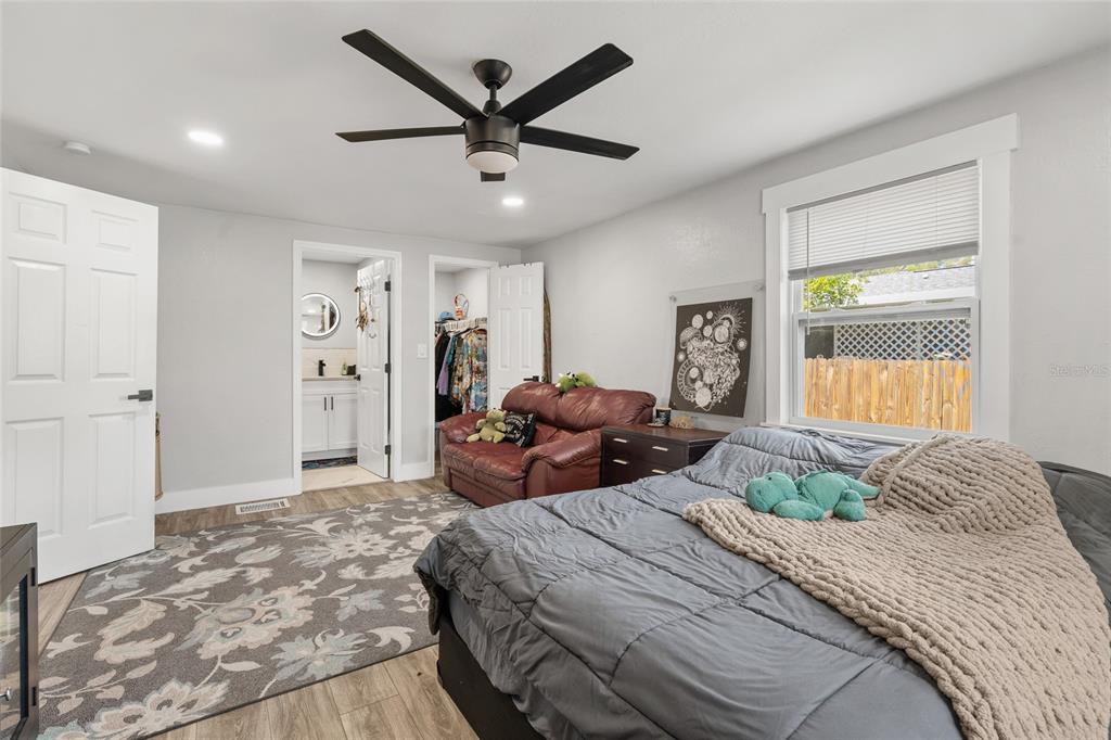 5135 Bradenton Road Sarasota, FL 34234 - Photo 17 of 30 a bedroom with a large bed and a chandelier