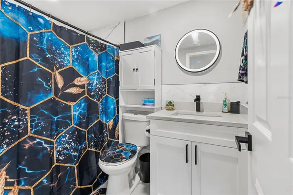 a bathroom with a toilet and a vanity