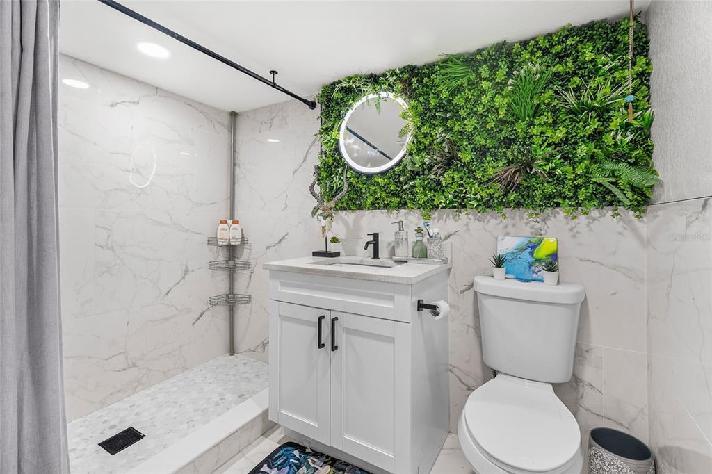 5135 Bradenton Road Sarasota, FL 34234 - Photo 22 of 30 a bathroom with a sink mirror vanity and toilet