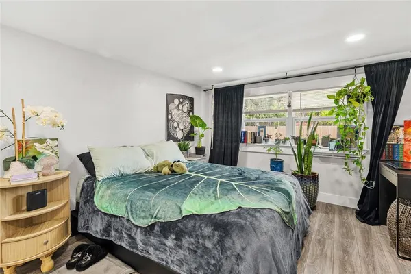 a bedroom with a bed and a painting on the wall