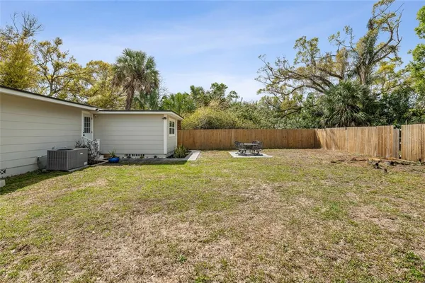 a backyard of a house with table and chairs